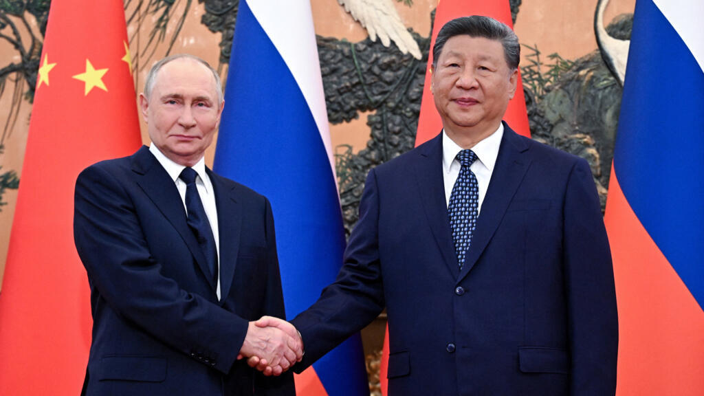 Russian President Vladimir Putin and Chinese President Xi Jinping pose for photos before their meeting in Beijing, China September 2, 2025.
