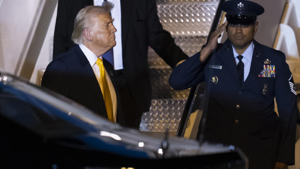President Donald Trump looks towards the White House traveling press as he arrives at Palm Beach International Airport, Friday, March 7, 2025, in West Palm Beach, Fla.
