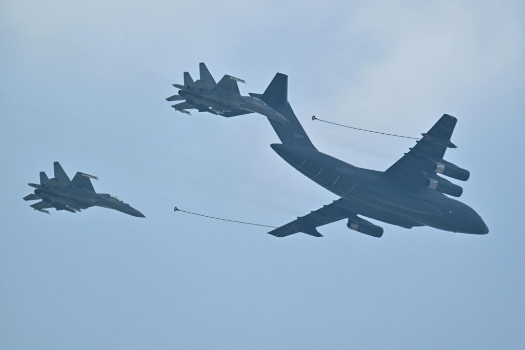 Military aircraft fly in formation during a military parade marking the 80th anniversary of victory over Japan and the end of World War II, in Beijing’s Tiananmen Square