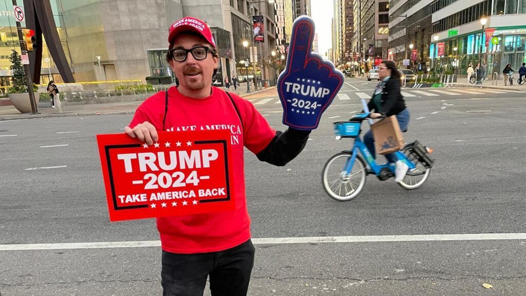 A Trump supporter shows off in the middle of Democratic stronghold Philadelphia, 3 November 2024.