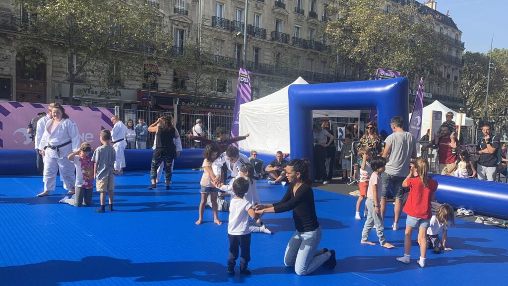 Jovens e idosos experimentam o judô com os olhos vendados durante o dia paraolímpico organizado na Praça da República em Paris, em 8 de outubro de 2023.