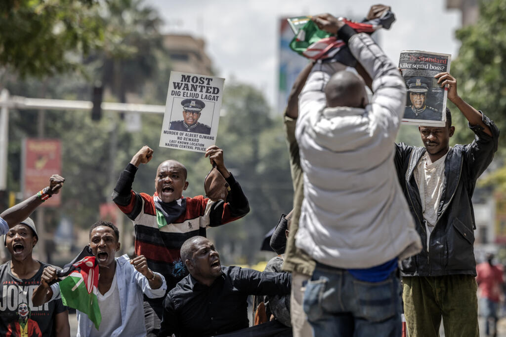 Protesters hold banners and chant slogans demanding the resignation of Eliud Lagat, Deputy Inspector General of the Kenya Police Service, during a demonstration over the death of Kenyan blogger Albert Ojwang, who died in police custody, in downtown Nairobi, on 12 June 2025. 