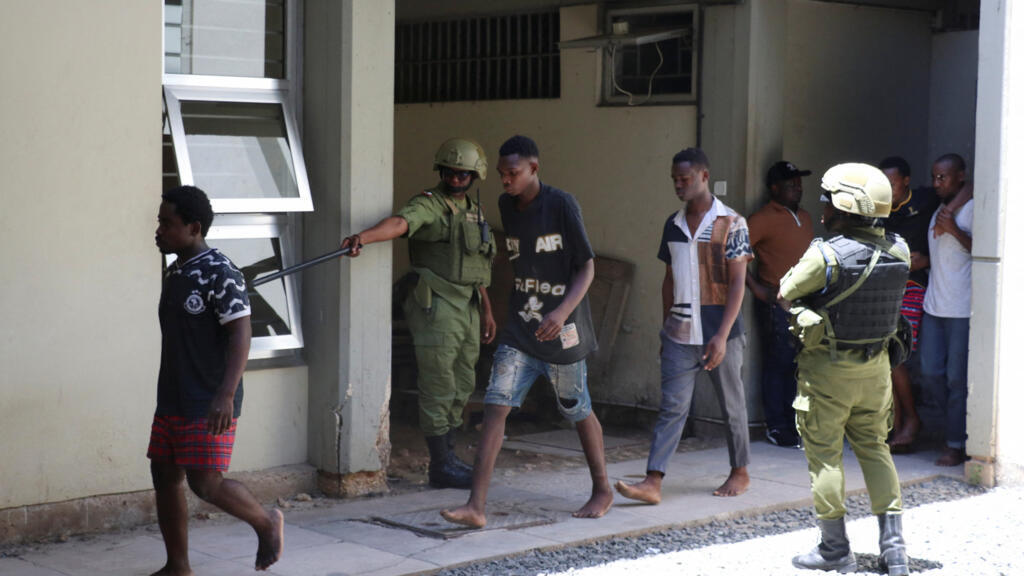 Tanzanians charged with treason for alleged involvement in violent protests that broke out during last week's presidential and parliamentary elections, walk in a formation as they arrive at the Kisutu Resident Magistrate's Court in Dar es Salaam, Tanzania, on 7 November, 2025.