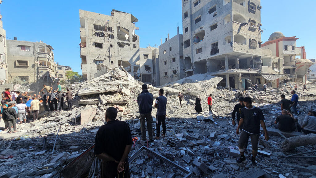 Palestinians gather at the site of Israeli strikes on houses and residential buildings, amid the ongoing Israel-Hamas conflict, in Beit Lahiya, in the northern Gaza Strip October 20, 2024.