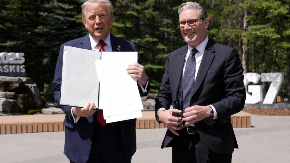 U.S. President Donald Trump holds a signed Trade Agreement with Britain during a meeting with British Prime Minister Keir Starmer, at the G7 summit, in Kananaskis, Alberta, Canada June 16, 2025.