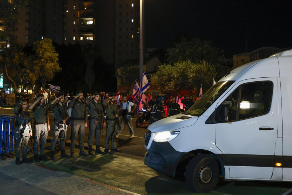 Israeli soldiers salute as four hostage bodies arrive for identification in Tel Aviv
