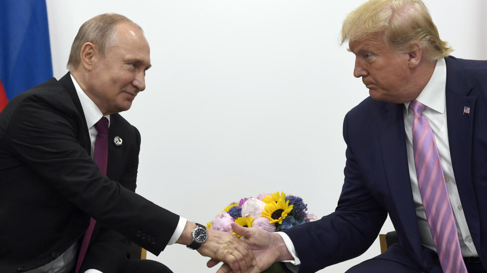 FILE - In this June 28, 2019, file photo, President Donald Trump, right, shakes hands with Russian President Vladimir Putin, left, during a bilateral meeting on the sidelines of the G-20 summit in Osa