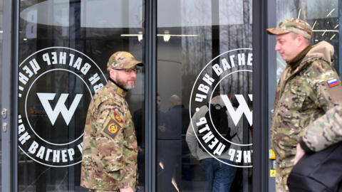 People dressed in military fatigues outside Wagner's headquarters in Saint Petersburg on 4 November 2022.