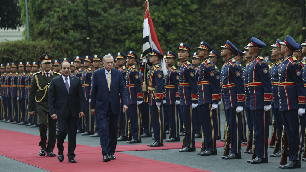 Turkey's President Recep Tayyip Erdogan and Egyptian President Abdel Fattah al-Sisi review an honour guard during their meeting at Al-Ittihadiya palace in Cairo, Egypt, on 14 February 2024.