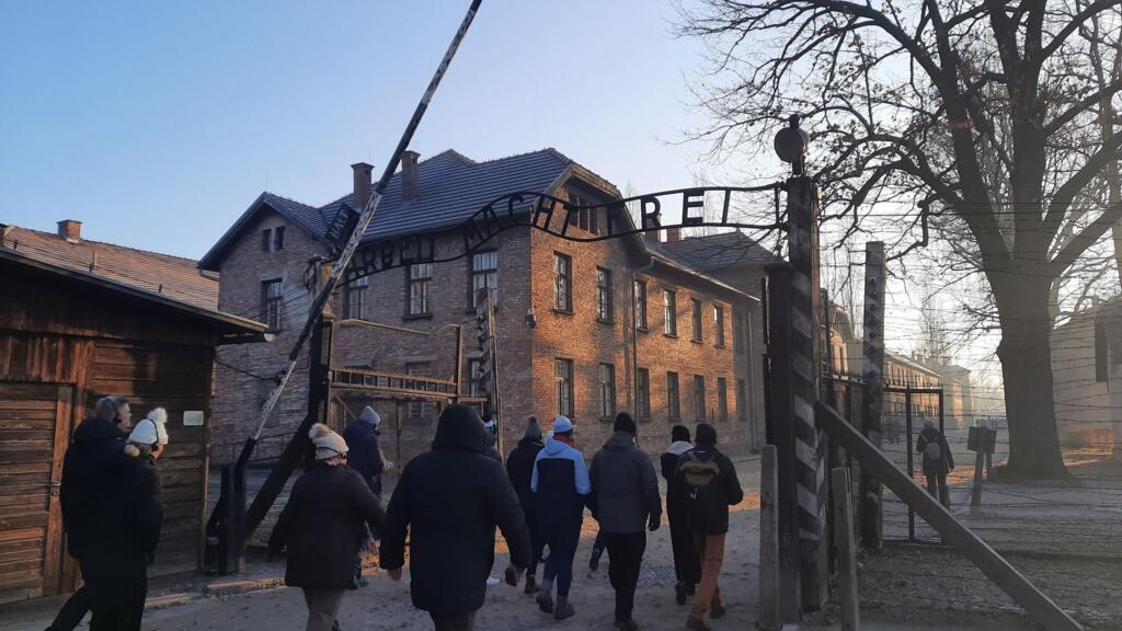 Visitantes na entrada do campo de concentração de Auschwitz.