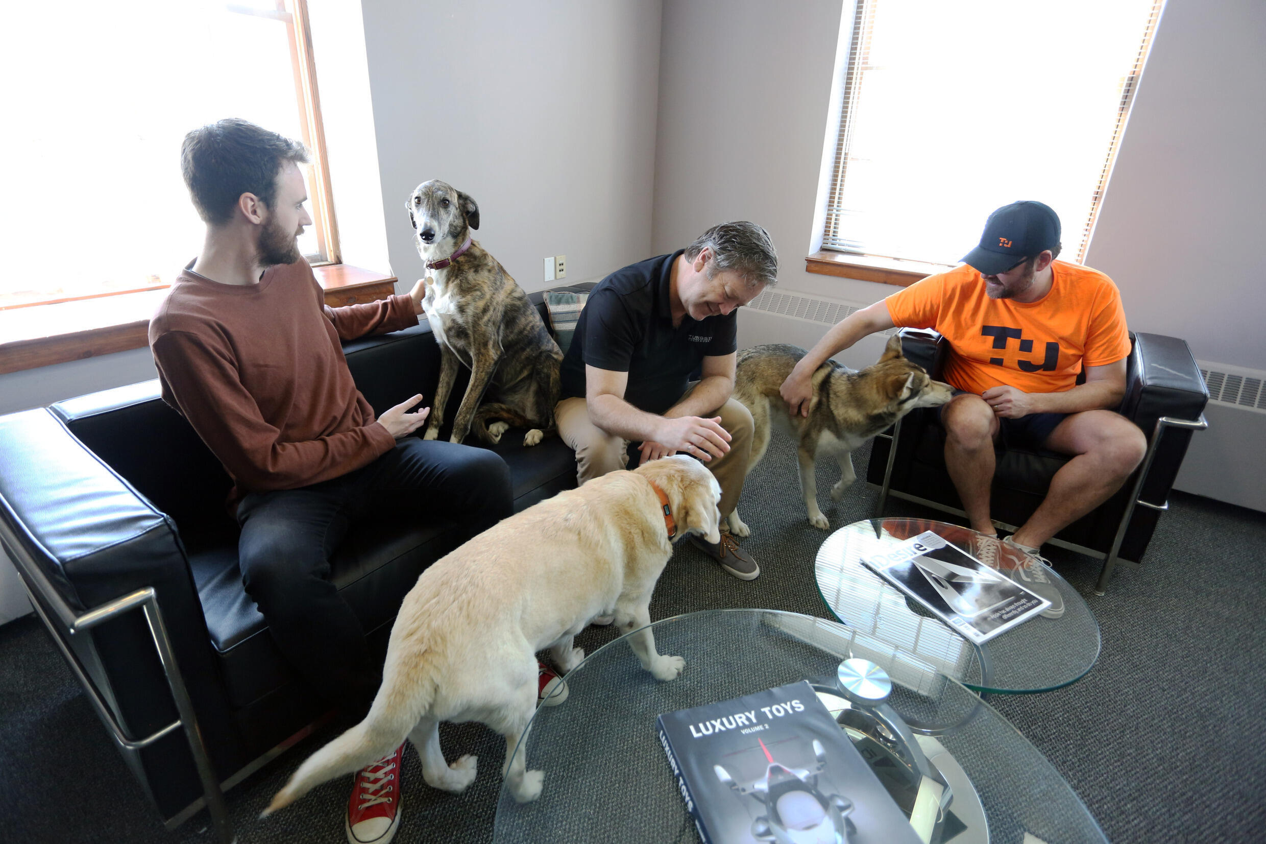 Johann van Halle, Dave McMulin and Phil Dyke of the Canadian company Tungsten Collaboration with their dogs in Ottawa, Canada on May 5, 2022