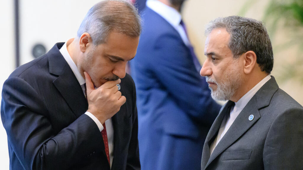 Iran foreign minister Abbas Araghchi (R) speaks with Turkey foreign minister Hakan Fidan (L) ahead the family photo during the 51st session of the Council of Foreign Ministers of the Organization of Islamic Cooperation (OIC) in Istanbul, on June 21, 2025.