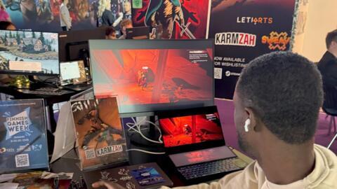 A gamer tests Leti Arts game Karmzah at Gamescom 2025 in Cologne, Germany.