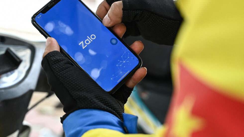 A man uses Zalo, a messaging app owned by Vietnamese internet startup VNG, on his mobile phone in Hanoi on August 24, 2023. Vietnamese internet firm VNG has filed for an initial public offering (IPO)