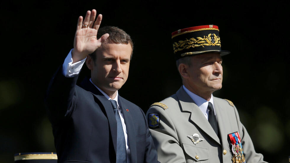 French President Emmanuel Macron and Chief of the Defence Staff French Army General Pierre de Villiers arrive in a command car for the traditional Bastille Day military parade on the Champs-Elysees in Paris, France, July 14, 2017.