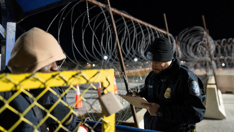 A U.S. Customs and Border Protection agent checks names of asylum seekers with appointments made through the U.S. Customs and Border Protection CBP One application scheduled for the morning of January