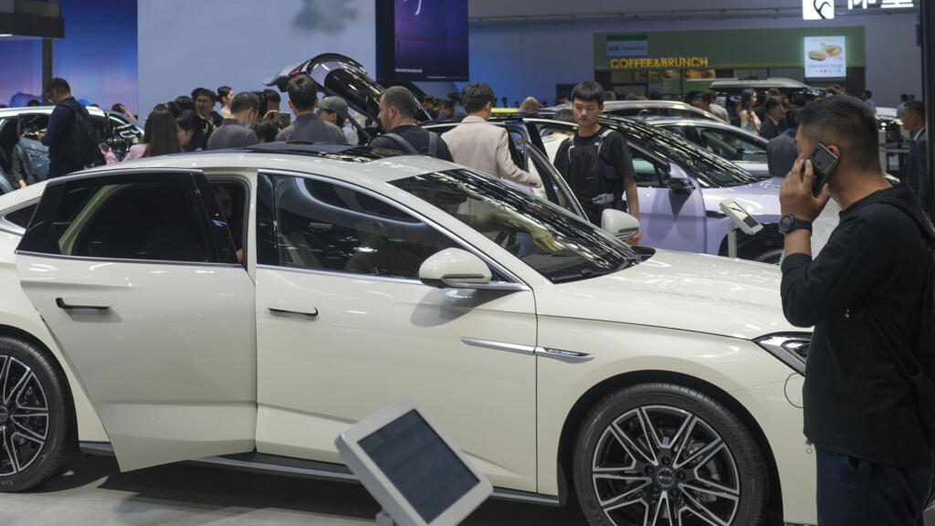 Visitors look at cars at the BYD booth during the China Auto Show in Beijing, China, Friday, 26 April, 2024.
