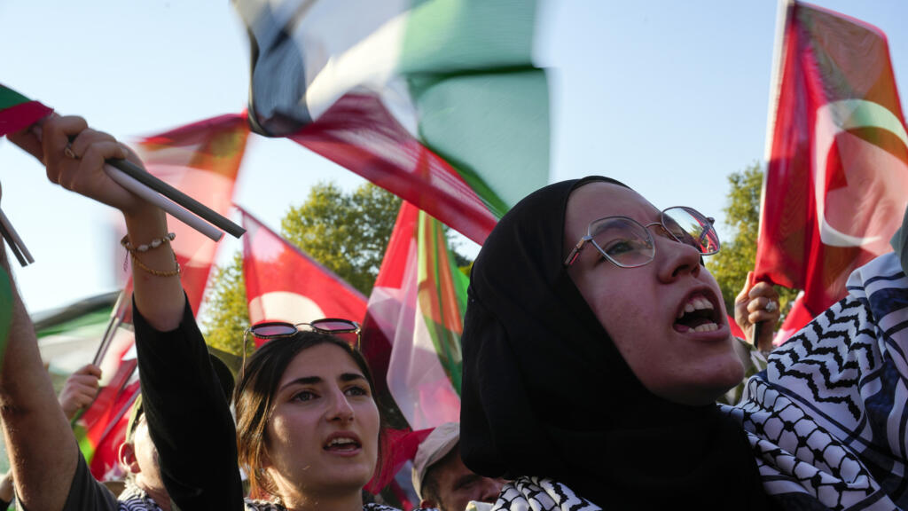 Demonstrators hold Palestinian and Turkish flags during a rally in support of Palestinians in Gaza, in Istanbul, Turkey, on 3 August 2024.