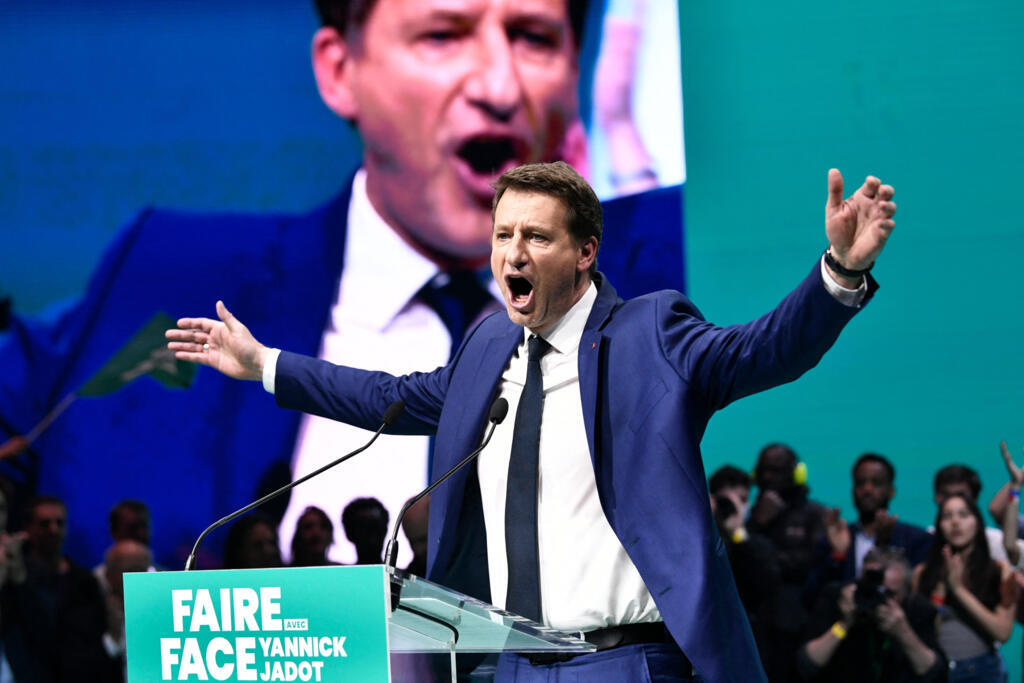 French ecologist party Europe Ecologie-Les Verts's (EELV) presidential candidate Yannick Jadot opens his arms as he speaks during a campaign meeting in Paris, on March 27, 2022