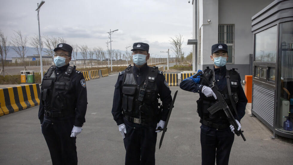 Police officers stand at the outer entrance of the Urumqi No. 3 Detention Center in Dabancheng in western China's Xinjiang Uyghur Autonomous Region on April 23, 2021. State officials took AP journalis