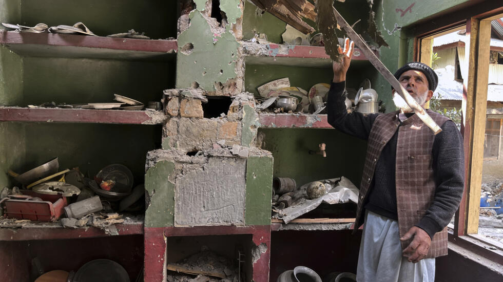 A Kashmiri villager examines damages to his house caused by overnight Indian shelling, in Shah Kot, in Neelum Vallery, a district of Pakistan's administered Kashmir, Saturday, May 10, 2025. (AP Photo/