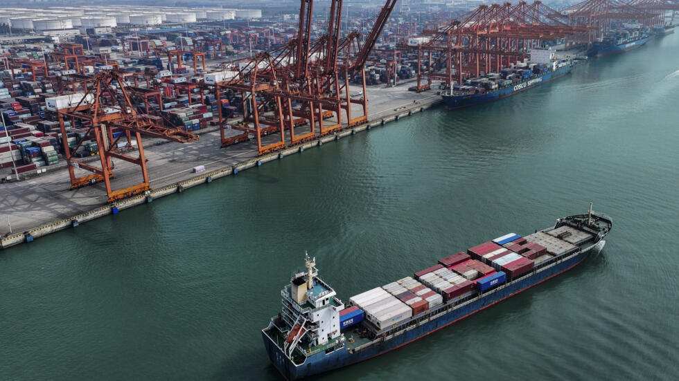 In this photo released by Xinhua News Agency, a container vessel sets off from the Qinzhou Port in Qinzhou City in south China's Guangxi Zhuang Autonomous Region on Nov. 24, 2023