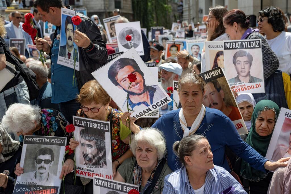 Turkish relatives hold portraits during the 1000th weekly vigil of the Saturday Mothers group for the victims who "disappeared" while in custody of state-linked agencies in the late 80s and 90s, in front of the Galatasaray High School in Istanbul on 25 May, 2024.