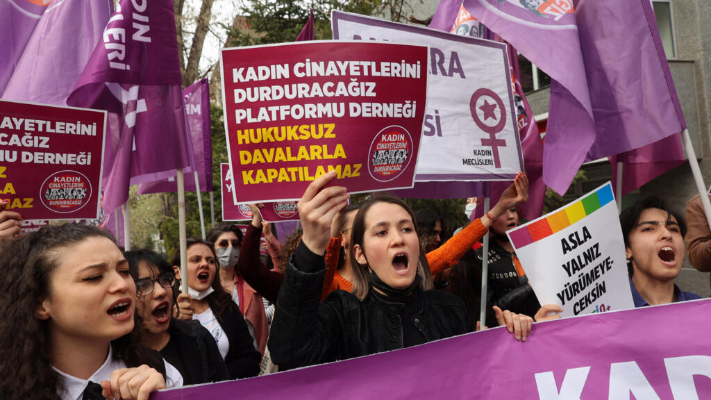 Women hold up banners and shout slogans as they protest against the closure case filed against the 'We Will Stop Femicide platform in Ankara on 16 April, 2022.